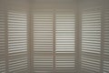 Luxury white indoor plantation shutters, closed shutters Royalty Free Stock Photo