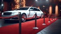 Luxury white limousine car with closed door near empty red carpet with rope barrier against night cityscape background. Celebrity