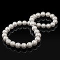 Luxury white pearl necklace on a black background with glossy reflection Royalty Free Stock Photo