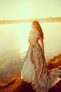 Luxury woman in a forest in a long vintage dress near the lake. Royalty Free Stock Photo