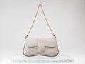 Luxury women 's bag. Luxury beige leather handbag on white background, on marble floor Royalty Free Stock Photo