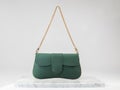 Luxury women 's bag. Luxury green leather handbag on white background, on marble floor Royalty Free Stock Photo