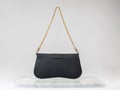 Luxury women 's bag. Luxury black leather handbag on white background, on marble floor Royalty Free Stock Photo