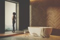 Wooden bathroom interior, white tub side toned Royalty Free Stock Photo