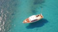 Luxury yacht in azure seas parked in a beautiful blue bay. Motorboat anchored near a beautiful mediterranean island.