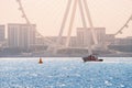 luxury yacht or boat sails along the Persian Gulf against the backdrop of the huge silhouette of one of the largest Ferris