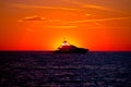 Luxury yacht on open sea at golden sunset