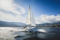 Luxury Yacht Sailing in Open Sea with Stunning Mountain Backdrop