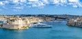 Luxury yachts and boats in front of ancient Valletta waterfront buildings and harbour. Valletta, Malta