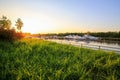 Luxury yachts docked in marina at colorful sunset. Modern boats parking at pier. Summer view of river bank. Royalty Free Stock Photo