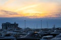 Luxury yachts docked in sea port at sunset. Marine parking of modern motor boats and blue water. Tranquility, relaxation Royalty Free Stock Photo