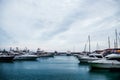 Luxury yachts docked in sea port at sunset. Marine parking of modern motor boats and blue water. Tranquility, relaxation Royalty Free Stock Photo