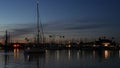 Yachts sailboats in marina harbour. Sail boat masts in twilight. Dusk in harbor, California USA.