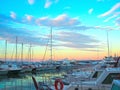 Luxury yachts and sailboats in seaport at sunset. Marine parking of modern motor boats in Liguria, Italia Royalty Free Stock Photo