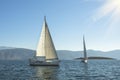 Luxury yachts in the sea near the Greek Islands in the rays of the rising sun.