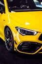 Luxury yellow Mercedes Benz during exhibition in closeup