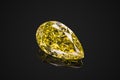 Luxury yellow transparent sparkling gemstone shape pear cut diamond isolated on black background Royalty Free Stock Photo