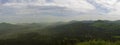 Luzicke hory mountains wide panorama, skyline view from hill stredni vrch, green forest and blue sky, white clouds background Royalty Free Stock Photo