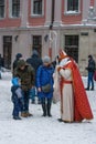 Lviv, downtown. Christmas time. Santa Claus Saint Nicholas gives sweets to children.