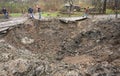 Lviv region, Ukraine - November 16, 2022: A people neare a crater after a Russian missile strike in a village, near the city of