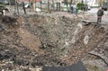 Lviv region, Ukraine - November 16, 2022: A people neare a crater after a Russian missile strike in a village, near the city of