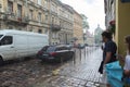 Lviv, UA, 05-08-2019. Old European city in the rain, street with driving cars. End of summer, beginning of autumn Royalty Free Stock Photo