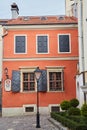 22.01.2020 Lviv, Ukraine. Ancient european style, exterior orange wall and vintage windows with iron shutters and retro lantern