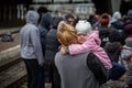 LVIV, UKRAINE - APR 02, 2022: War in Ukraine. Little girl on mom`s shoulder. Refugees from the evacuation train from Mariupol,