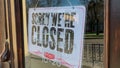 Lviv, Ukraine - April 26, 2021: Close sign wooden board hanging on glass door store. Close store or barbershop from