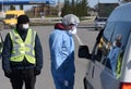 Lviv, Ukraine - April 10, 2020: Medical worker checks temperature of a driver on a checkpoint on the entrance to Lviv region.