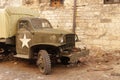 Lviv, Ukraine - 9 9 2019: Army american cars on a street destroyed by war. Scenery for the Holocaust feature film during