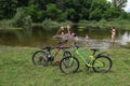 Two bicycles parked on the shore of forest lake Royalty Free Stock Photo