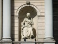 A three-meter allegorical statue of a seated woman with a dagger