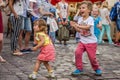 LVIV, UKRAINE - AUGUST 2016: Young children catching soap bubbles in the city, playing, joyful and radiating positive emotions, ha Royalty Free Stock Photo