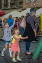 LVIV, UKRAINE - AUGUST 2016: Young children catching soap bubbles in the city, playing, joyful and radiating positive emotions, ha Royalty Free Stock Photo