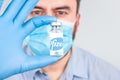 Lviv, Ukraine - Dec 28, 2020 : Doctor or scientist wearing medical face mask and holding Pfizer Biontech vaccine - protection