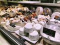 Lviv, Ukraine - December 25, 2018: Dutch cheeses, edam, gouda, whole round wheels on a wooden shelf, cheese shop Royalty Free Stock Photo