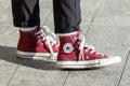 Person wearing red pair of Converse Chuck Taylor All Stars on the street Royalty Free Stock Photo