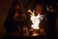 LVIV, UKRAINE - December 2, 2018. Tourists watch the preparation of extreme coffee. Caramelized coffee. Fire show Royalty Free Stock Photo