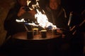 LVIV, UKRAINE - December 2, 2018. Tourists watch the preparation of extreme coffee. Caramelized coffee. Fire show