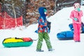 LVIV, UKRAINE - January 7, 2019: children sliding snow tube down by snowed hill