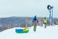 LVIV, UKRAINE - January 7, 2019: children sliding snow tube down by snowed hill