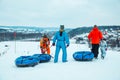 LVIV, UKRAINE - January 7, 2019: family ride down by snowing hill with snow tube