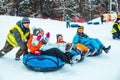 LVIV, UKRAINE - January 7, 2019: family ride down by snowing hill with snow tube