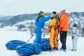 LVIV, UKRAINE - January 7, 2019: family ride down by snowing hill with snow tube