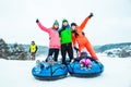 LVIV, UKRAINE - January 7, 2019: family ride down by snowing hill with snow tube