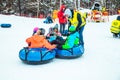 LVIV, UKRAINE - January 7, 2019: family ride down by snowing hill with snow tube