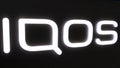IQOS store neon signboard. Close-up of IQOS logo