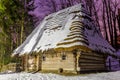 LVIV, UKRAINE - January 31, 2021: Old wooden retro house in the Shevchenko Grove Old village in winter and at night