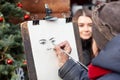 Lviv, Ukraine - January 2, 2020: Street Artist Draws Sketch Portrait of a beautiful girl